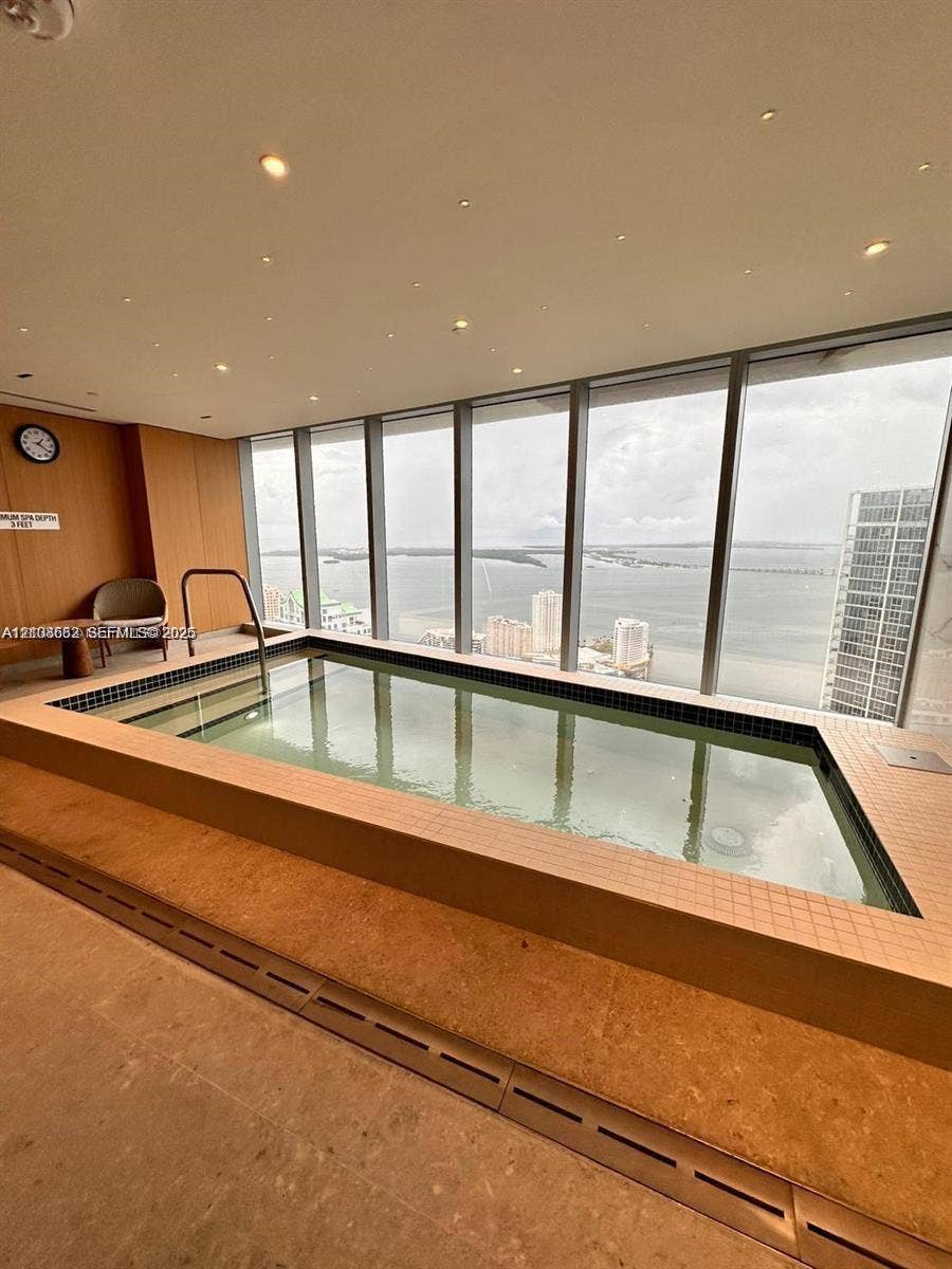300 Biscayne Boulevard, #2709W, Miami, Miami, FL 33131 Indoor pool featuring floor-to-ceiling windows, tile surround, recessed lighting, and wood-paneled walls