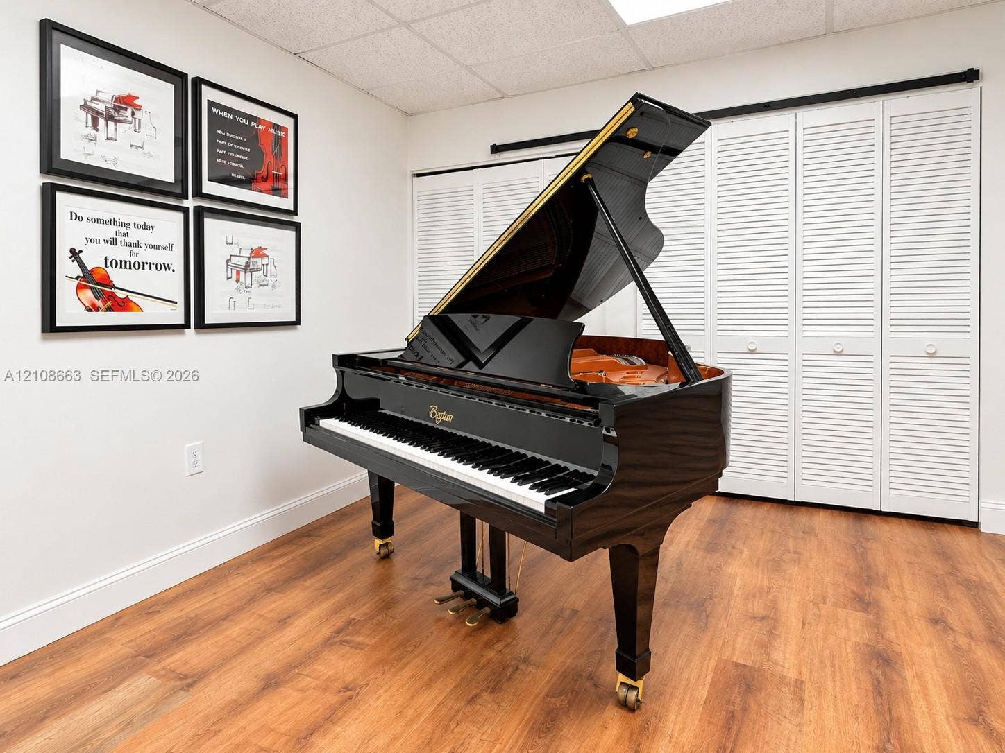 Doral, Doral, FL 33166 Wood-finish flooring paired with white louvered bifold closet doors and acoustic ceiling tiles