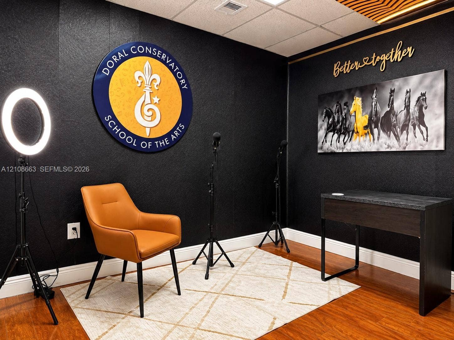 Doral, Doral, FL 33166 Interior space featuring black textured walls, wood-finish flooring, and recessed ceiling lighting with an integrated decorative slat detail