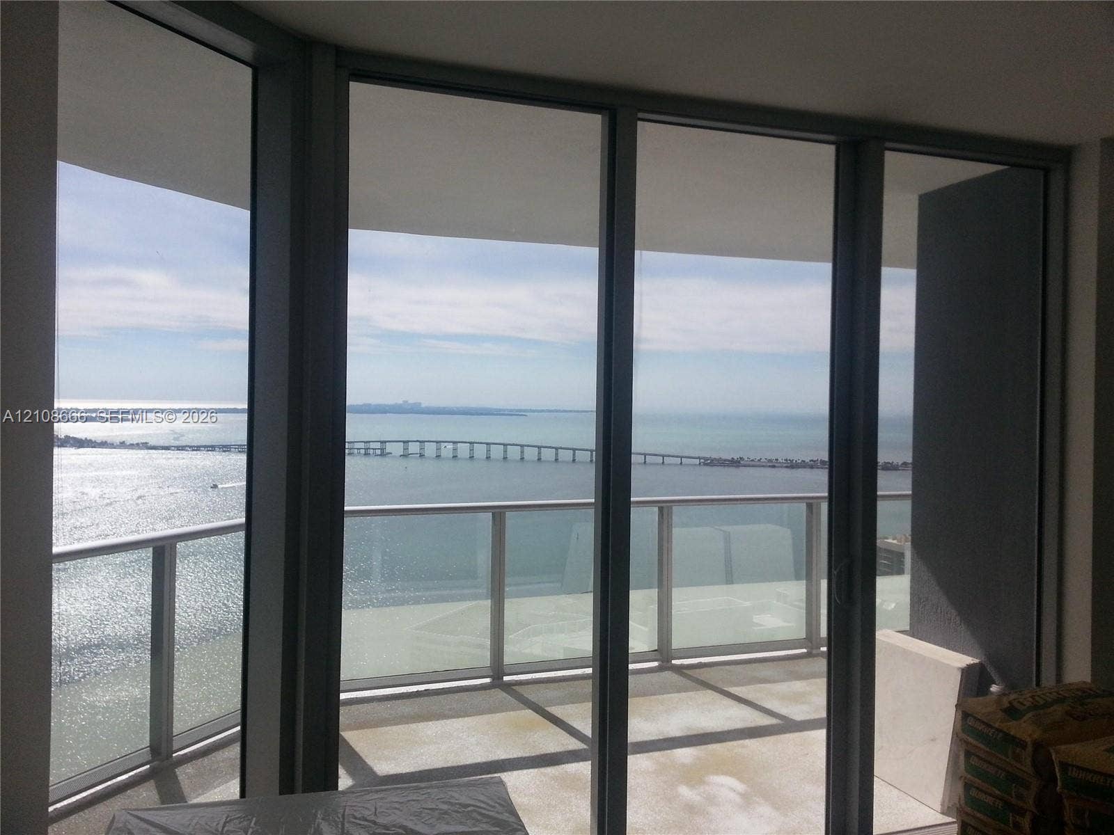 1300 Brickell Bay Drive, #3506, Miami, FL 33131 Floor-to-ceiling glass panel windows, metal-framed sliding glass doors, and a private balcony with a glass railing