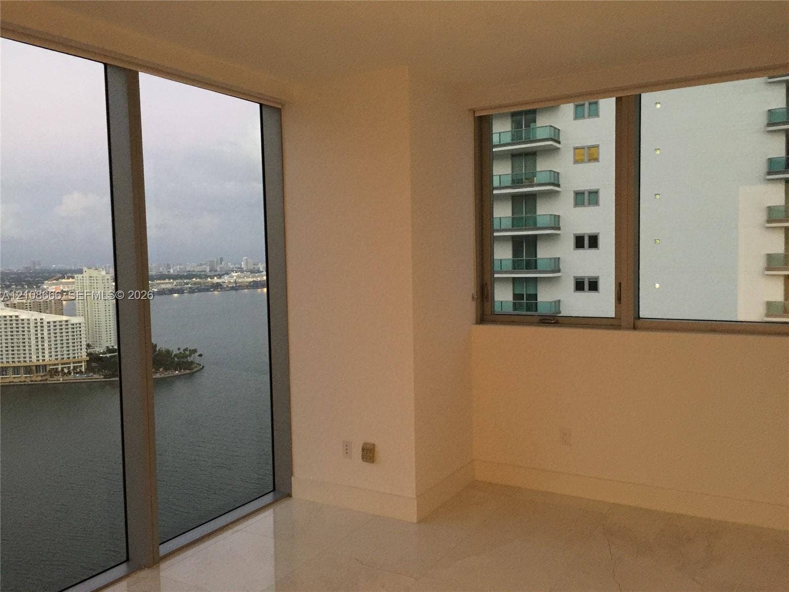1300 Brickell Bay Drive, #3506, Miami, FL 33131 Floor-to-ceiling windows with metal framing, expansive water exposure, and light-toned flooring