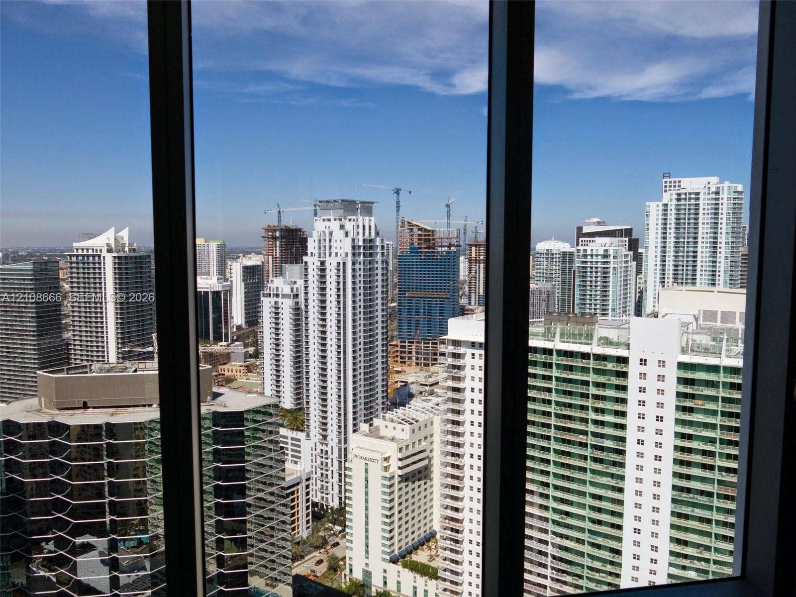 1300 Brickell Bay Drive, #3506, Miami, FL 33131 Floor-to-ceiling windows with dark-finish mullions framing an expansive cityscape