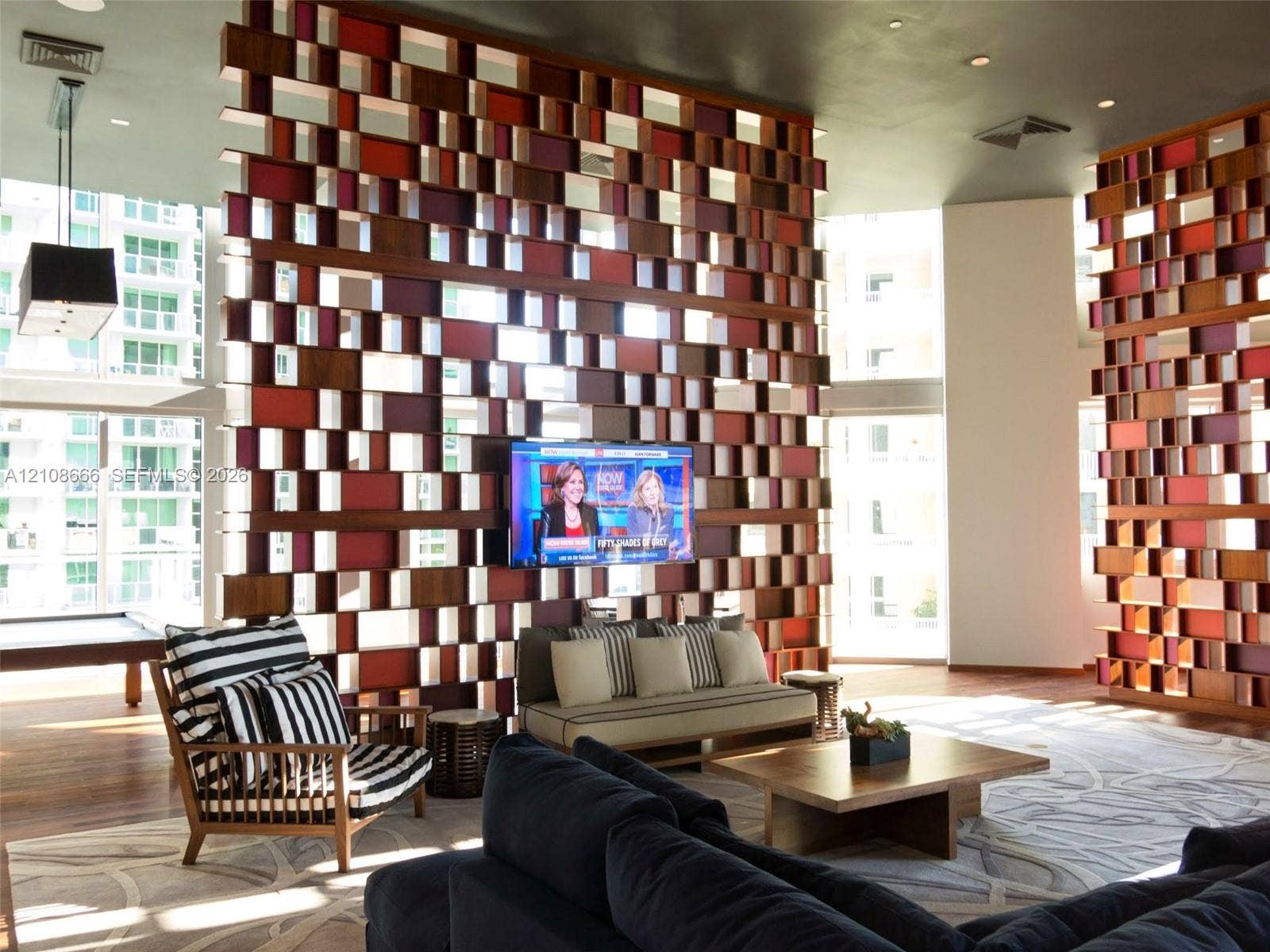 1300 Brickell Bay Drive, #3506, Miami, FL 33131 Custom wood-grid architectural room divider with integrated television mount and high ceilings featuring recessed lighting