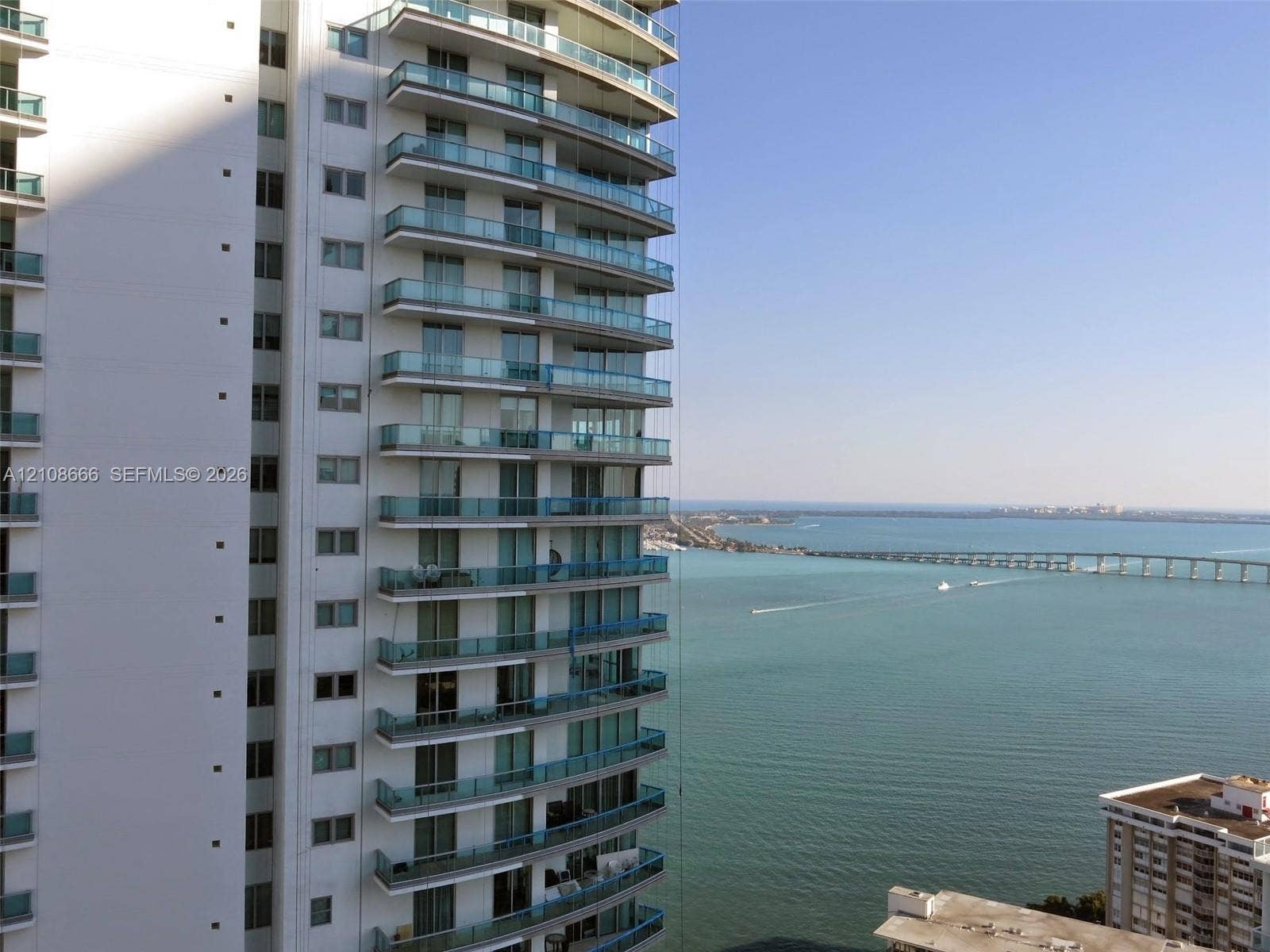 1300 Brickell Bay Drive, #3506, Miami, FL 33131 High-rise building exterior featuring tiered concrete balconies with glass railings and floor-to-ceiling windows