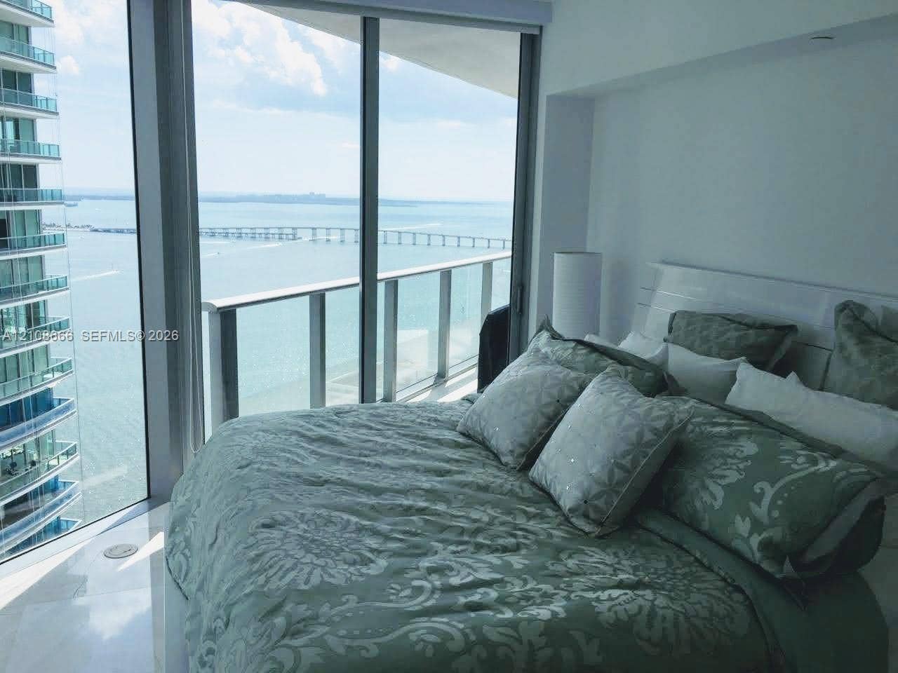 1300 Brickell Bay Drive, #3506, Miami, FL 33131 Floor-to-ceiling windows, attached glass-railed balcony, and polished stone flooring