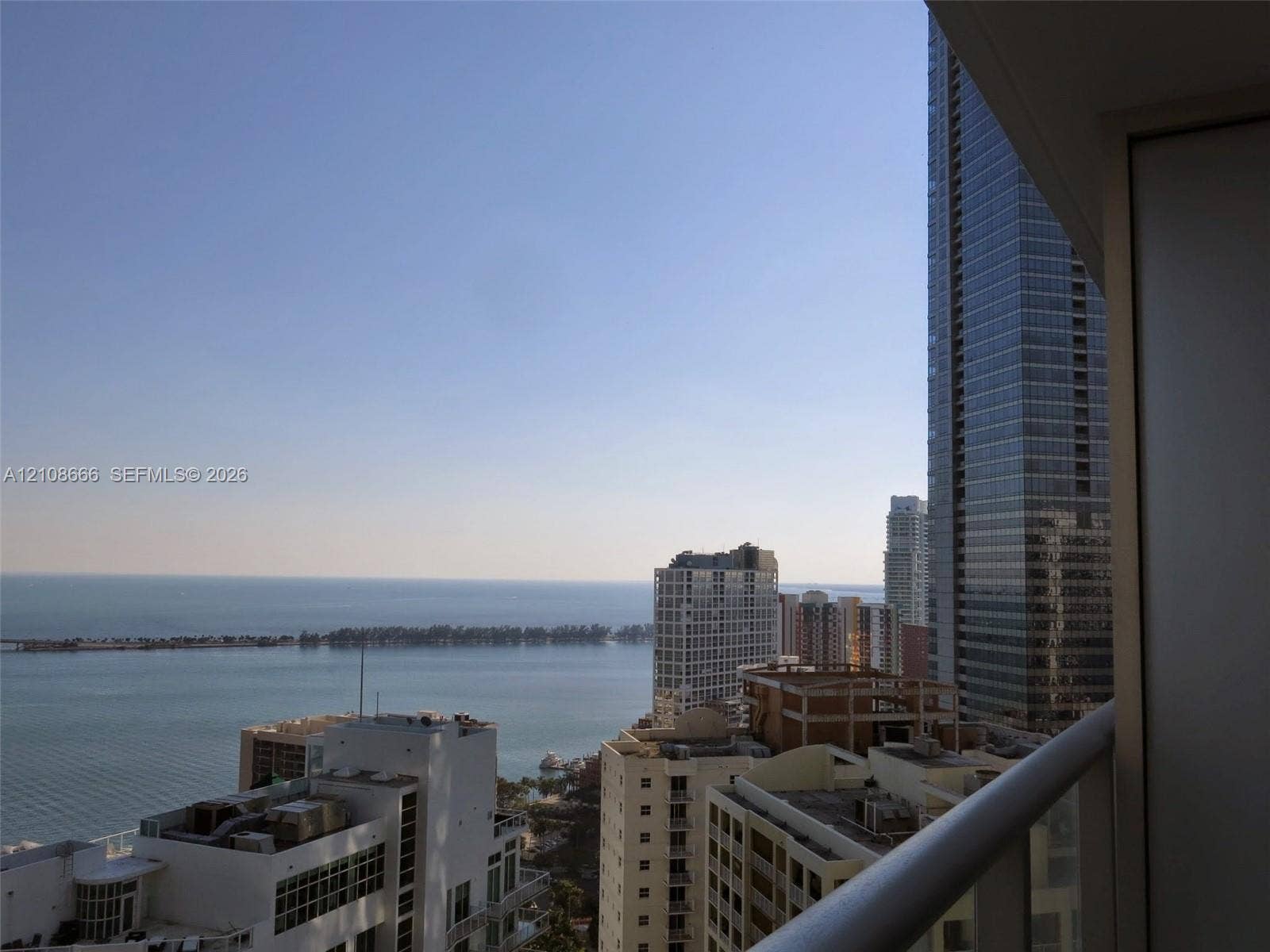 1300 Brickell Bay Drive, #3506, Miami, FL 33131 Private balcony with a metal railing, showcasing an expansive waterfront and urban skyline