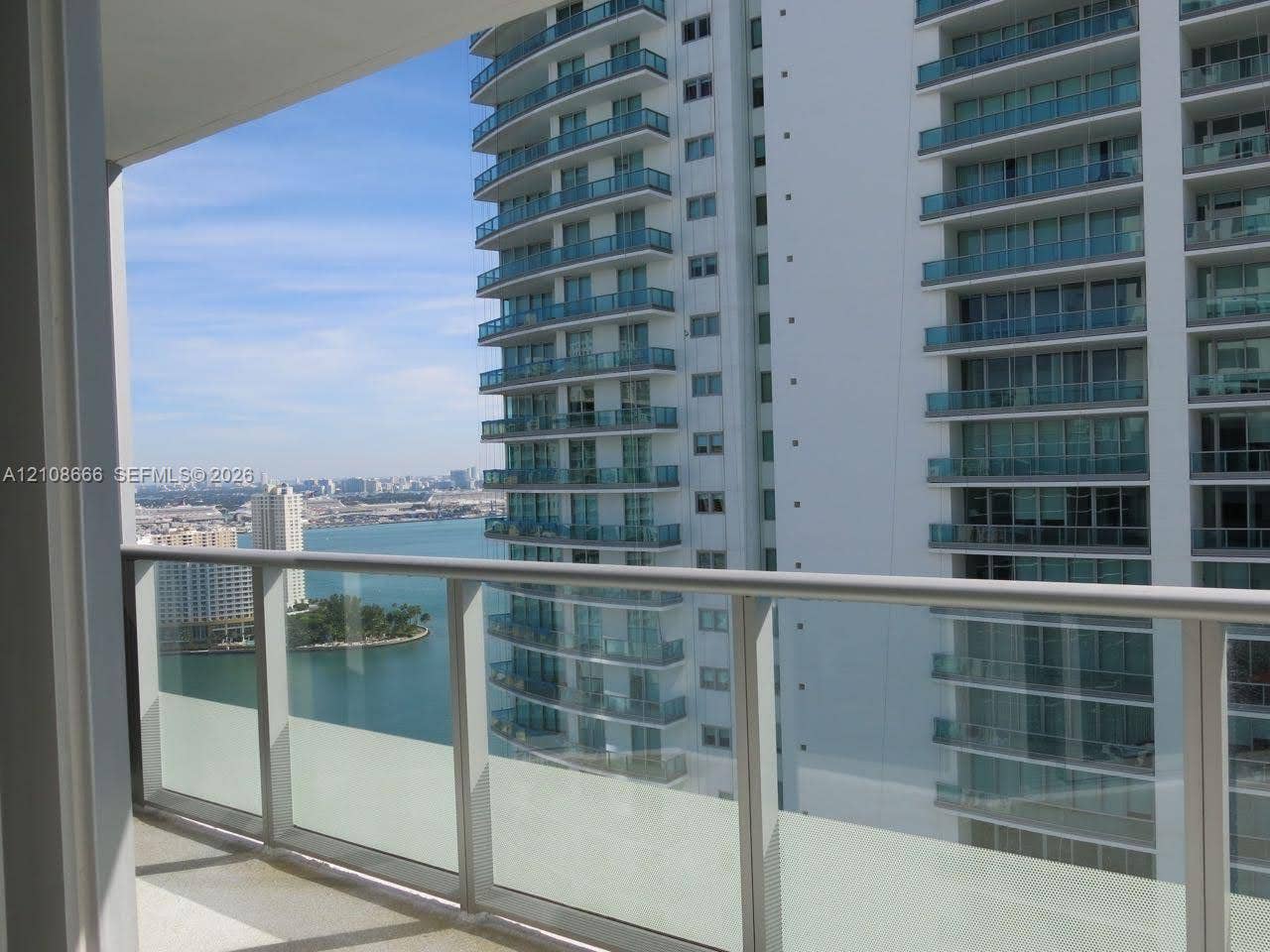 1300 Brickell Bay Drive, #3506, Miami, FL 33131 Private balcony with a glass and metal railing, concrete flooring, and water scenery