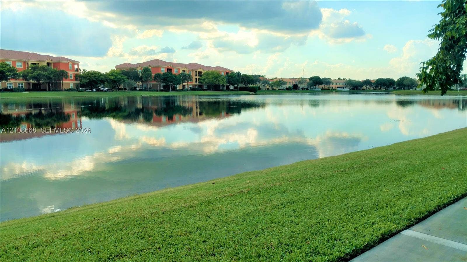 4508 SW 160th Avenue, #734, Miramar, Miramar, FL 33027 Expansive lakefront setting featuring a manicured lawn and concrete walking path