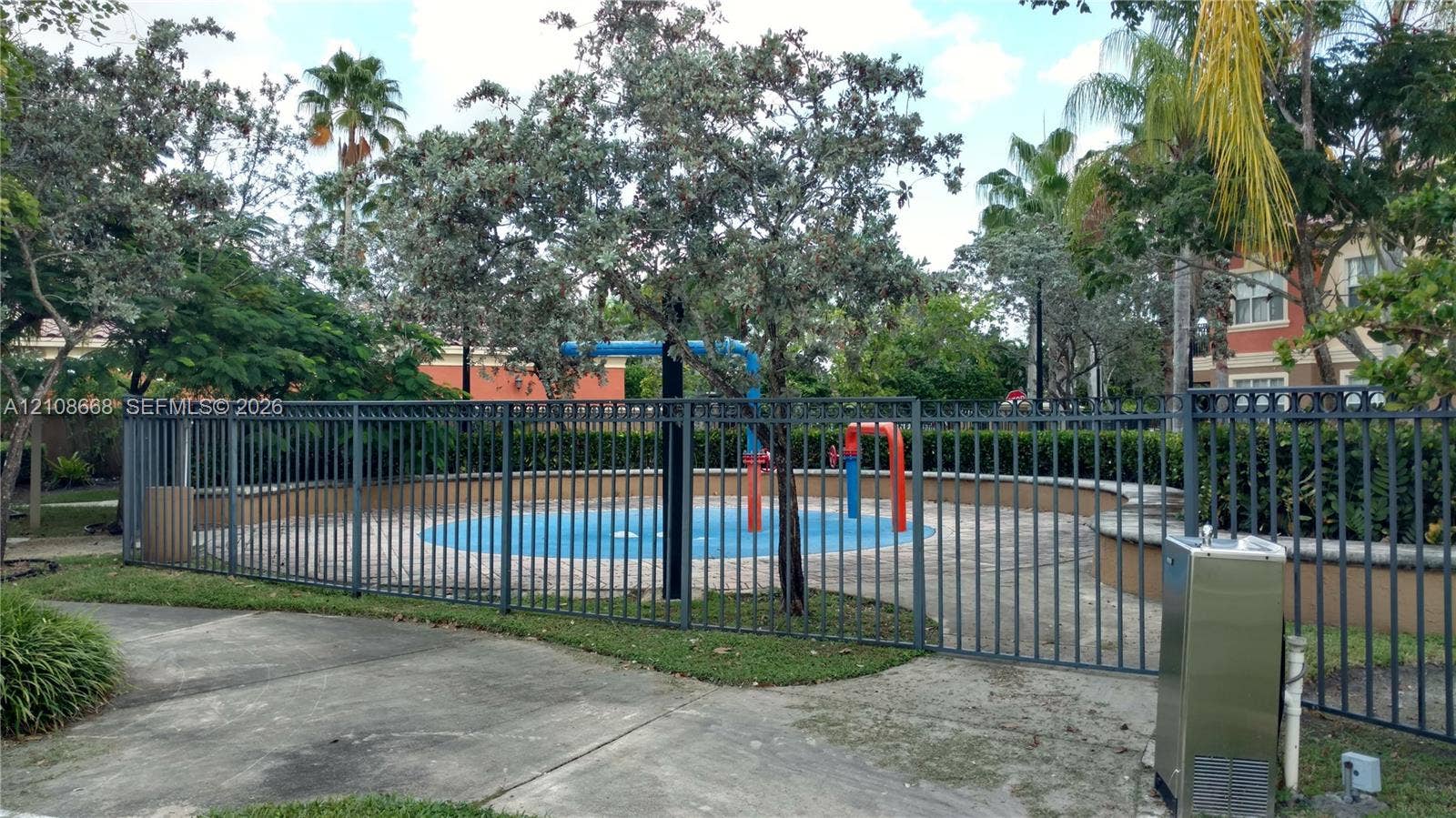 4508 SW 160th Avenue, #734, Miramar, Miramar, FL 33027 Outdoor splash pad featuring a concrete deck, built-in water features, and a metal perimeter fence