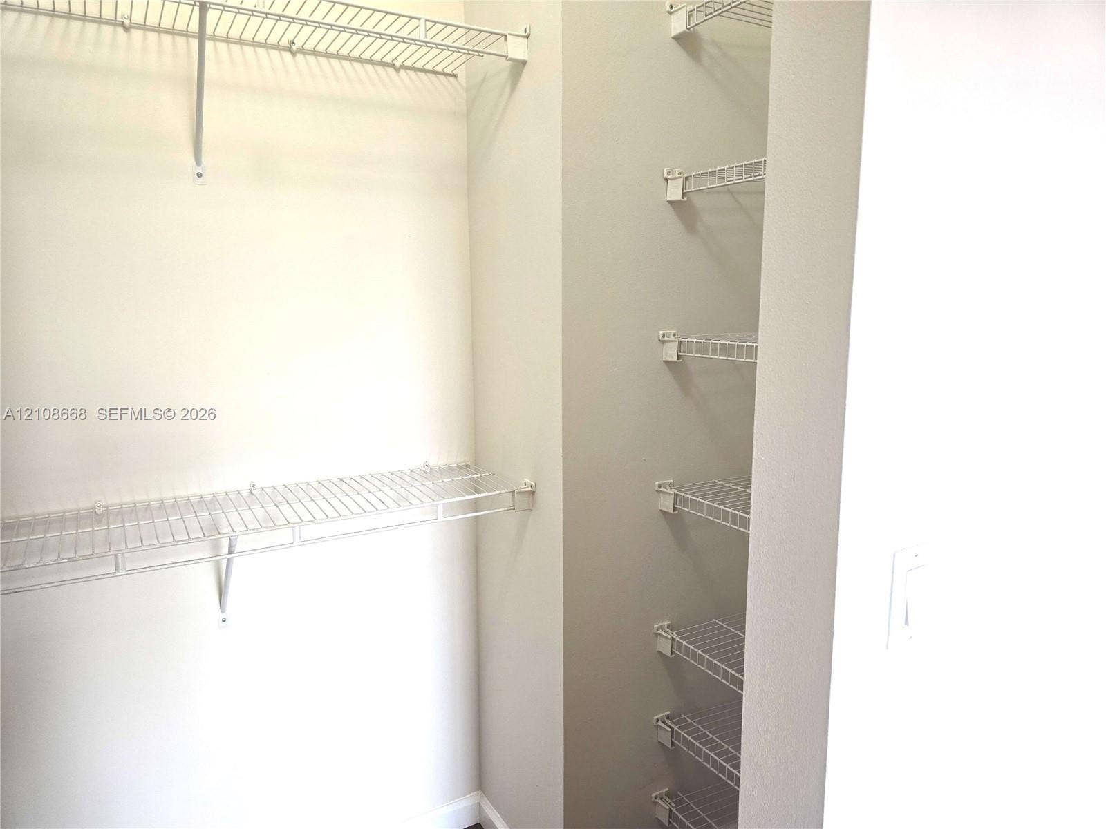 4508 SW 160th Avenue, #734, Miramar, Miramar, FL 33027 Storage area featuring white wire shelving units and wall-mounted racks
