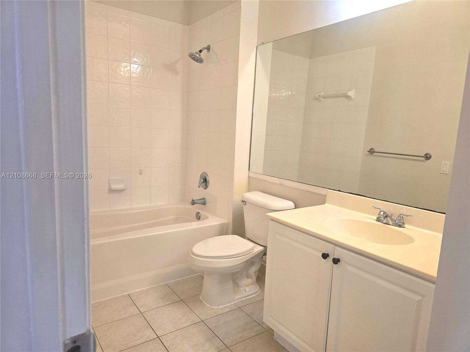 4508 SW 160th Avenue, #734, Miramar, Miramar, FL 33027 Full bathroom featuring a tub-shower combination with tile surround, vanity with an integrated basin, large wall-mounted mirror, and tile flooring