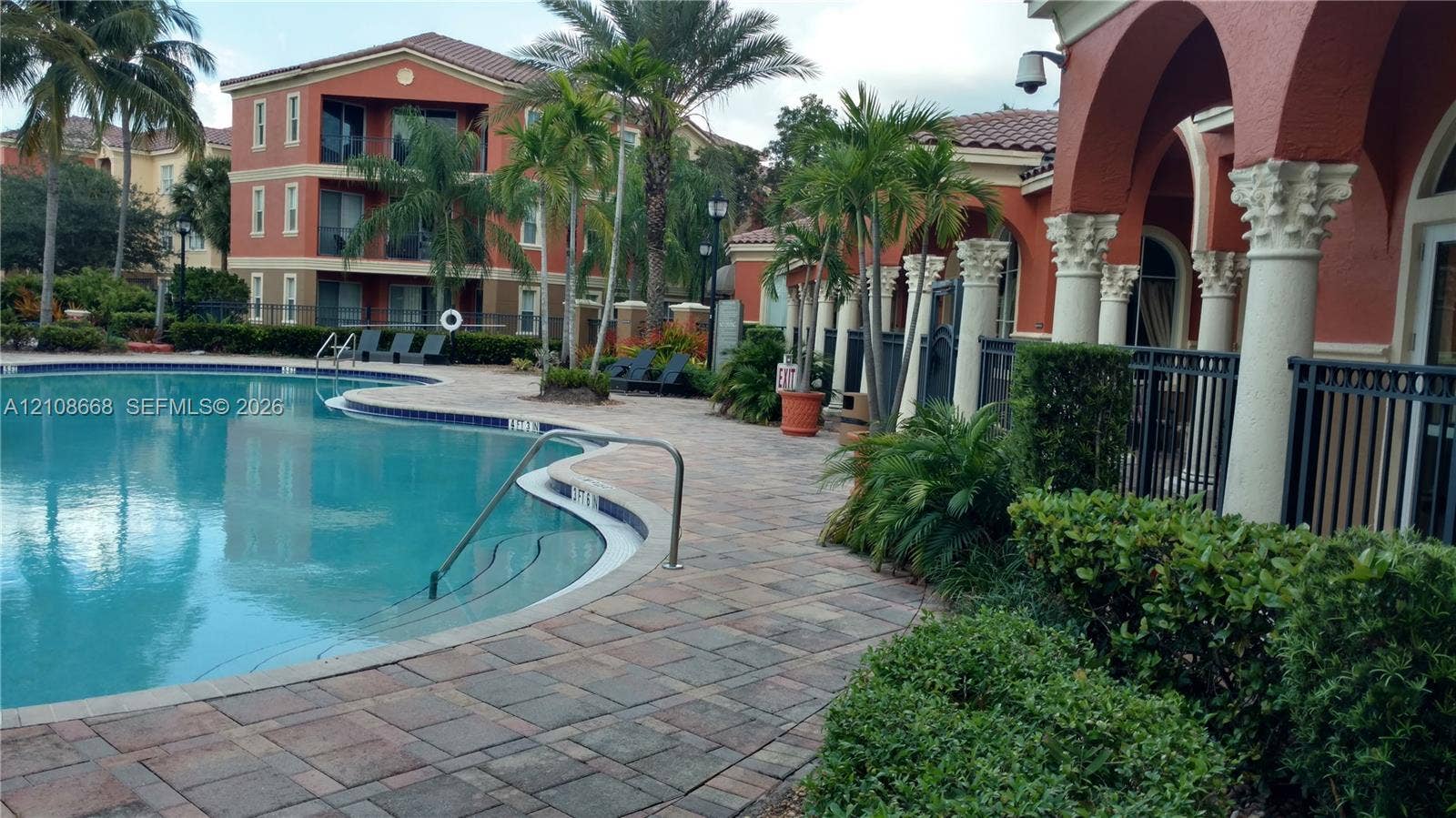 4508 SW 160th Avenue, #734, Miramar, Miramar, FL 33027 Swimming pool with integrated entry stairs, surrounded by a paver deck, ornamental columns, and mature landscaping