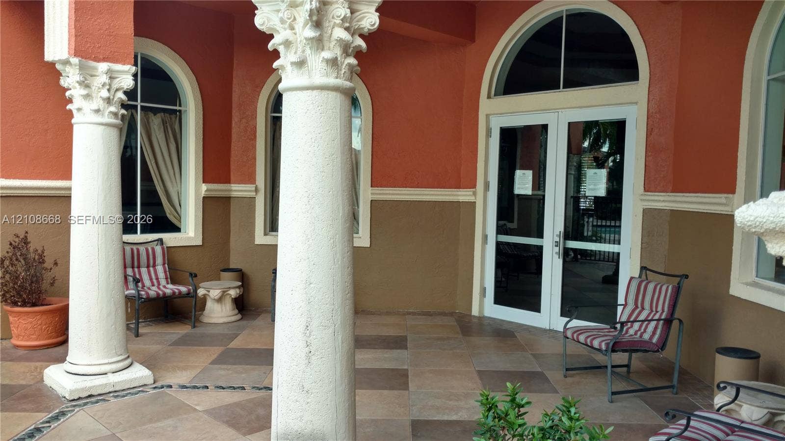 4508 SW 160th Avenue, #734, Miramar, Miramar, FL 33027 Covered patio featuring decorative Corinthian-style columns, arched window detailing, and multi-toned tile flooring