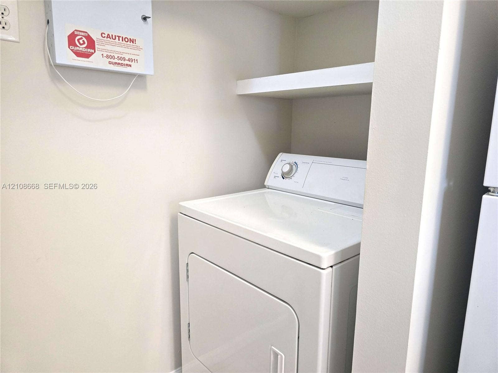4508 SW 160th Avenue, #734, Miramar, Miramar, FL 33027 Built-in laundry alcove featuring overhead shelving and an integrated security system wall panel
