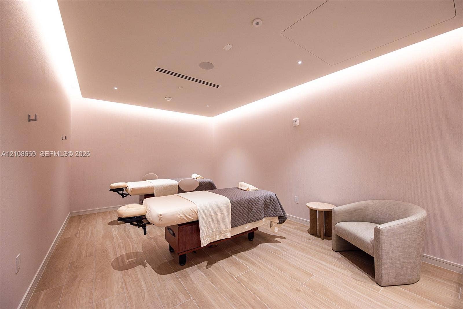 Interior space featuring wood-finish flooring, recessed perimeter lighting, and neutral wall tones