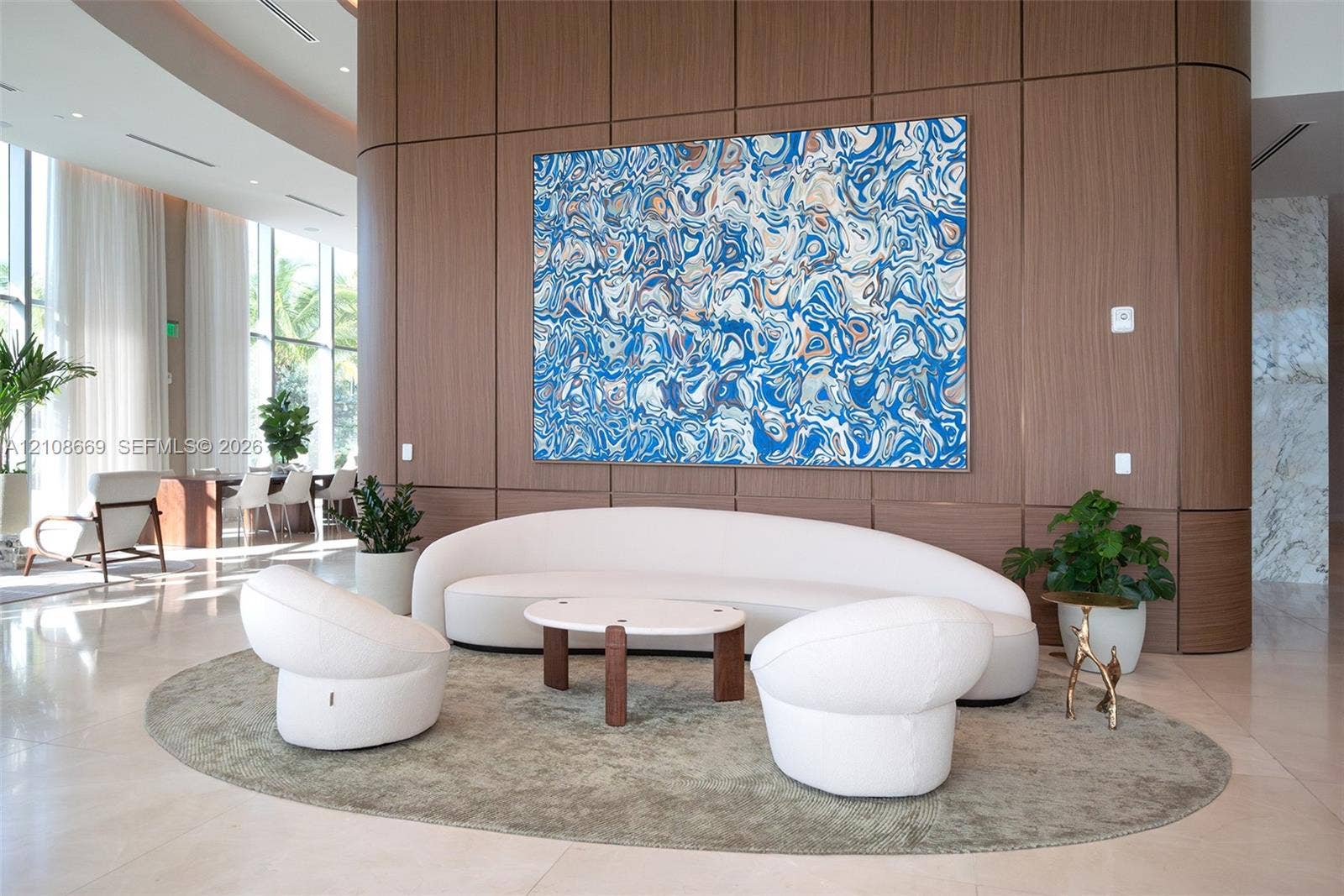 Full-height wood-panel accent wall with curved architectural detailing, floor-to-ceiling glass windows, and polished stone-finish flooring