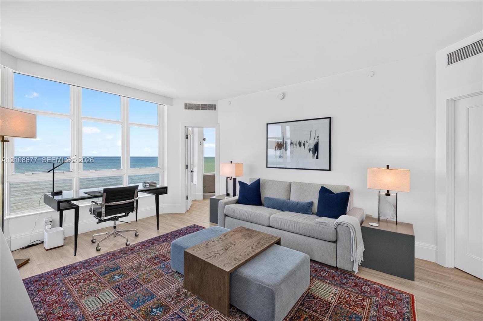 1440 S Ocean Boulevard, #11A, Lauderdale By The Sea, FL 33062 Expansive windows featuring water views, light-toned wood look plank porcelain flooring, and double layered (light filtering and room darkening) remote operated window shades by Bandalux