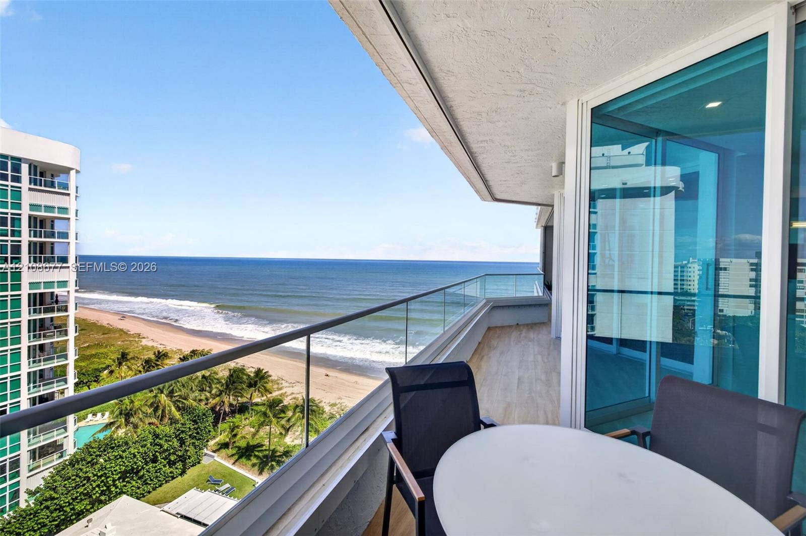 1440 S Ocean Boulevard, #11A, Lauderdale By The Sea, FL 33062 Private balcony featuring glass panel railing, tile flooring, and floor-to-ceiling glass sliding doors. Additional protection for your furniture with upgraded accordion shutters.