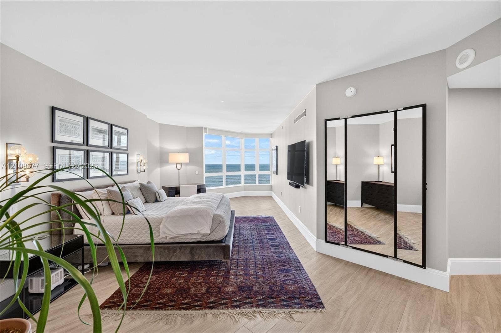 1440 S Ocean Boulevard, #11A, Lauderdale By The Sea, FL 33062 Wood look plank porcelain flooring, floor-to-ceiling bay windows, and a multi-panel mirror dressing area. This is said to be the only unit in the building with a built in primary sitting area (instead of small balcony space). Original developer enclosed the space for first owner.