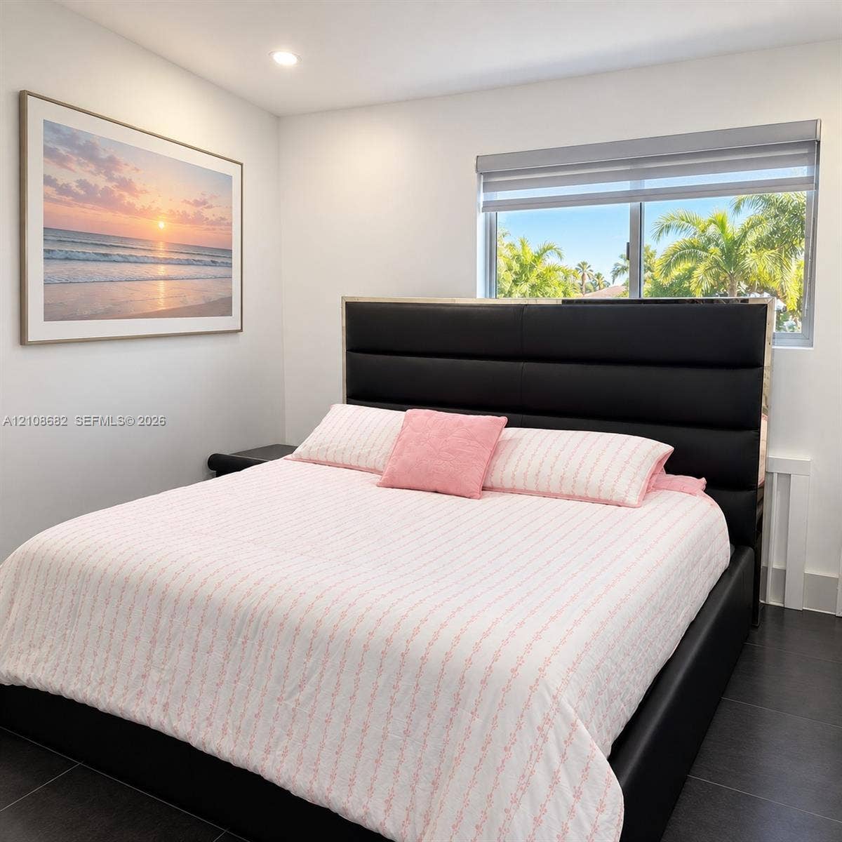 8943 NW 112th Terrace, Hialeah Gardens, FL 33018 Neutral-toned walls, dark tiled flooring, and a window with roller-style shade featuring palm tree exterior scenery