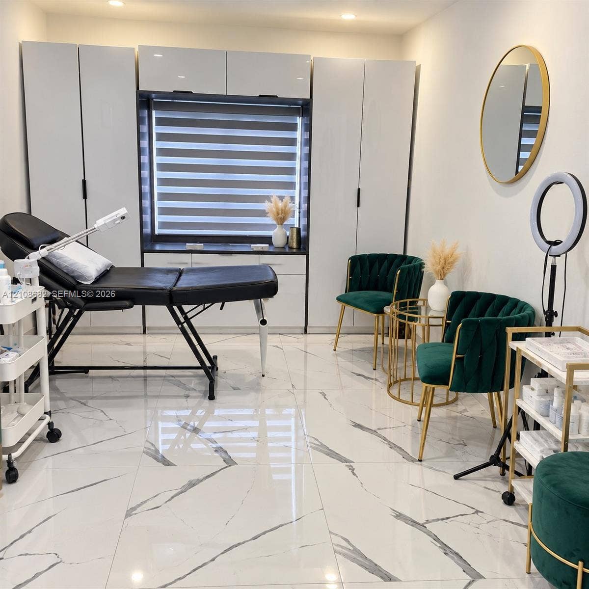8943 NW 112th Terrace, Hialeah Gardens, FL 33018 High-gloss tile flooring with a neutral-toned veined pattern, floor-to-ceiling built-in cabinetry with matte black hardware, integrated window storage unit, layered window shades, and recessed ceiling lighting
