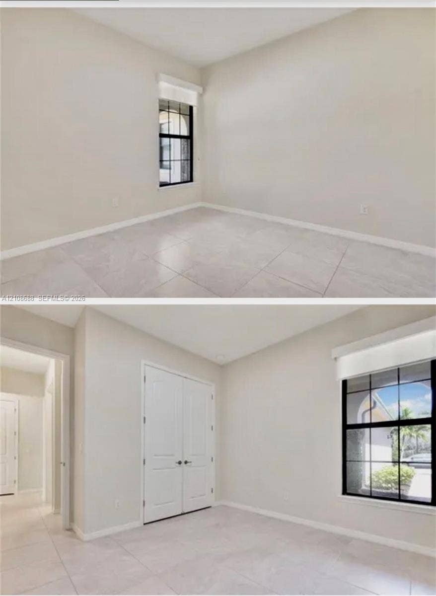 Neutral-toned ceramic tile flooring, dual-panel closet doors, and a window with a black muntin grid pattern