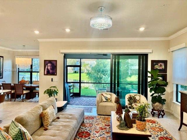 Open-concept interior featuring recessed lighting, a crystal-accented ceiling fan, ceramic tile flooring, and multi-panel sliding glass doors opening to a screened-in lanai