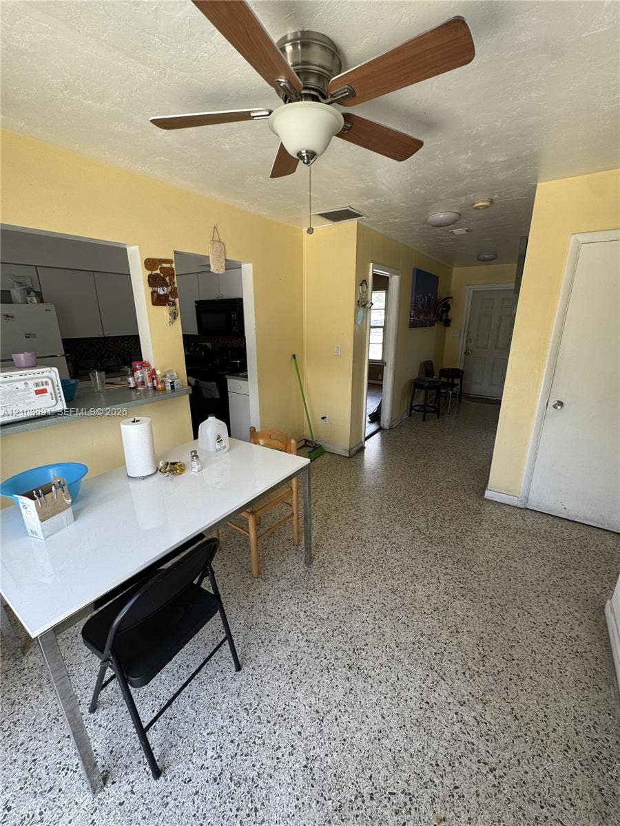 17210 NW 47th Avenue, Miami Gardens, FL 33055 Terrazzo flooring, ceiling fan with integrated lighting, pass-through opening to kitchen, and interior doors