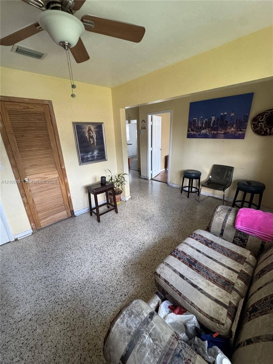 17210 NW 47th Avenue, Miami Gardens, FL 33055 Terrazzo flooring, louvered wood closet door, and a ceiling-mounted fan with integrated light fixture