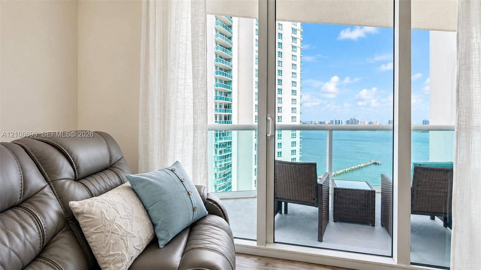 231 Riverside Drive, #1210, Daytona Beach, Daytona Beach, FL 32117 Floor-to-ceiling sliding glass door providing external access to a balcony with a glass railing and waterfront scenery