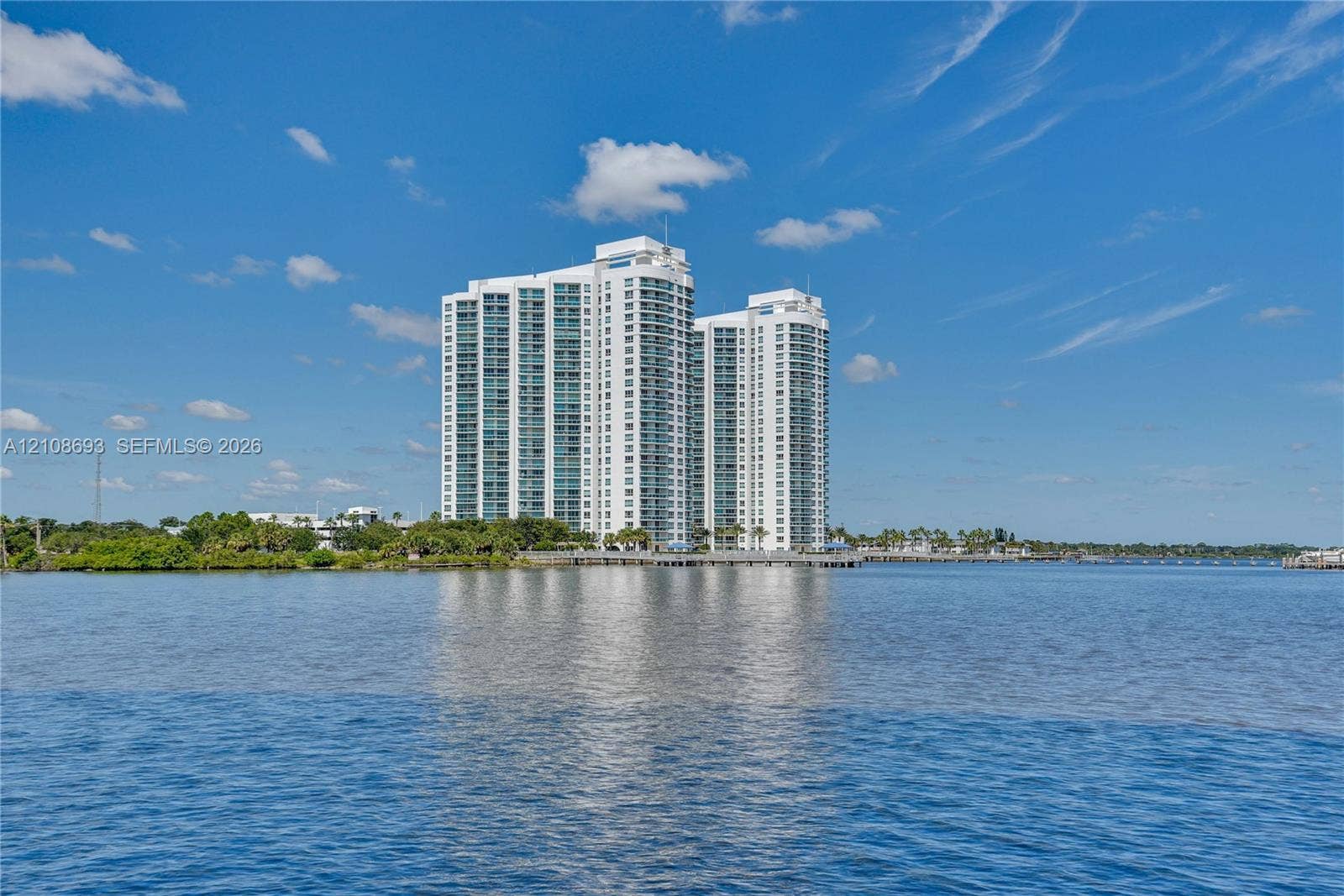 231 Riverside Drive, #1210, Daytona Beach, Daytona Beach, FL 32117 High-rise residential towers featuring expansive glass curtain walls, white structural exterior finish, and direct waterfront positioning