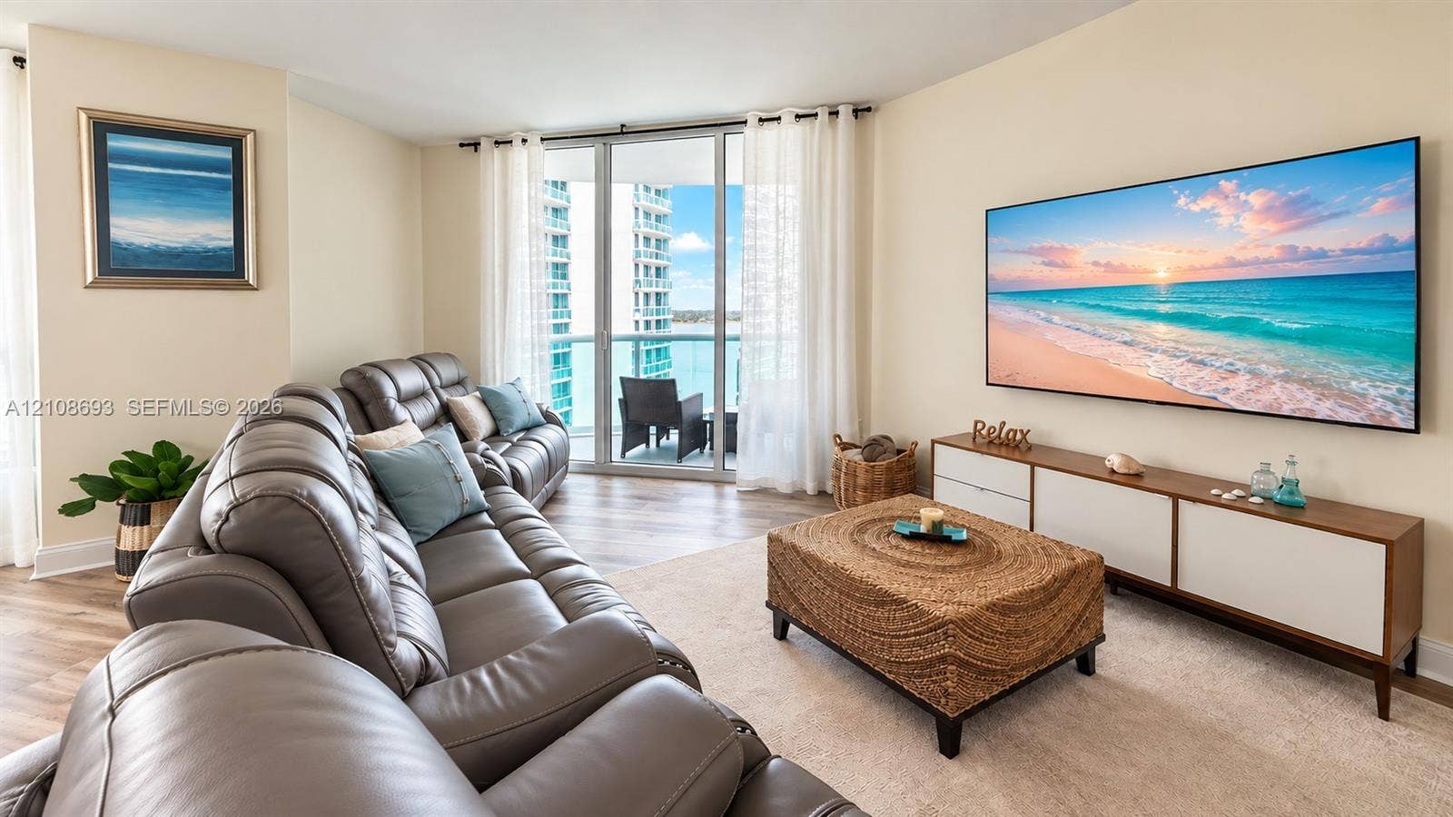 231 Riverside Drive, #1210, Daytona Beach, Daytona Beach, FL 32117 Floor-to-ceiling glass sliding doors, wood-finish flooring, and expansive water backdrop