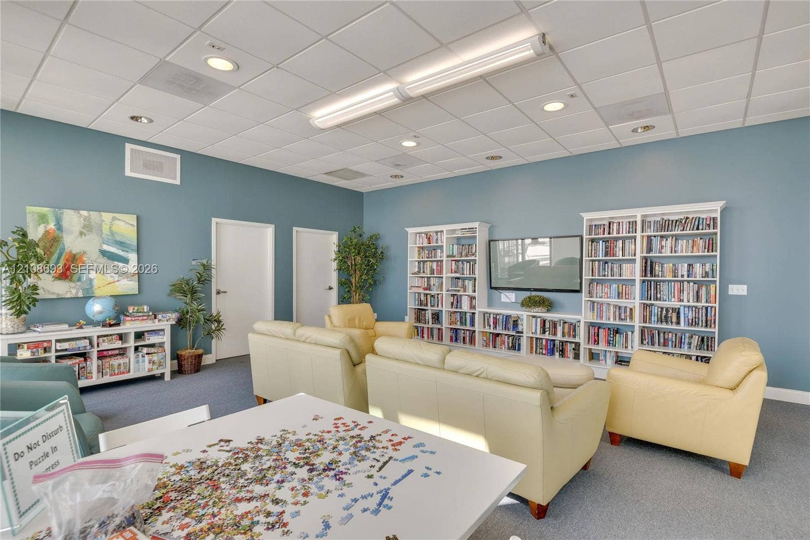 231 Riverside Drive, #1210, Daytona Beach, Daytona Beach, FL 32117 Expansive room featuring wall-to-wall built-in shelving, high-set acoustic tile ceiling, and recessed lighting