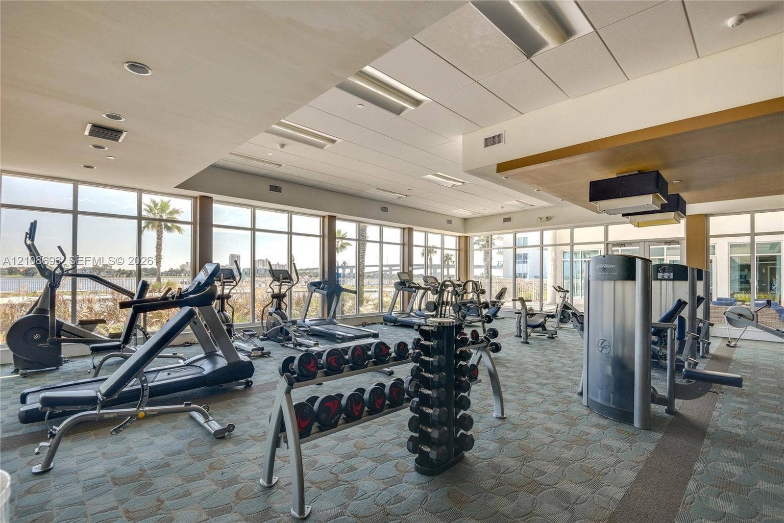 231 Riverside Drive, #1210, Daytona Beach, Daytona Beach, FL 32117 Fitness center featuring floor-to-ceiling windows, recessed lighting, and patterned carpeting