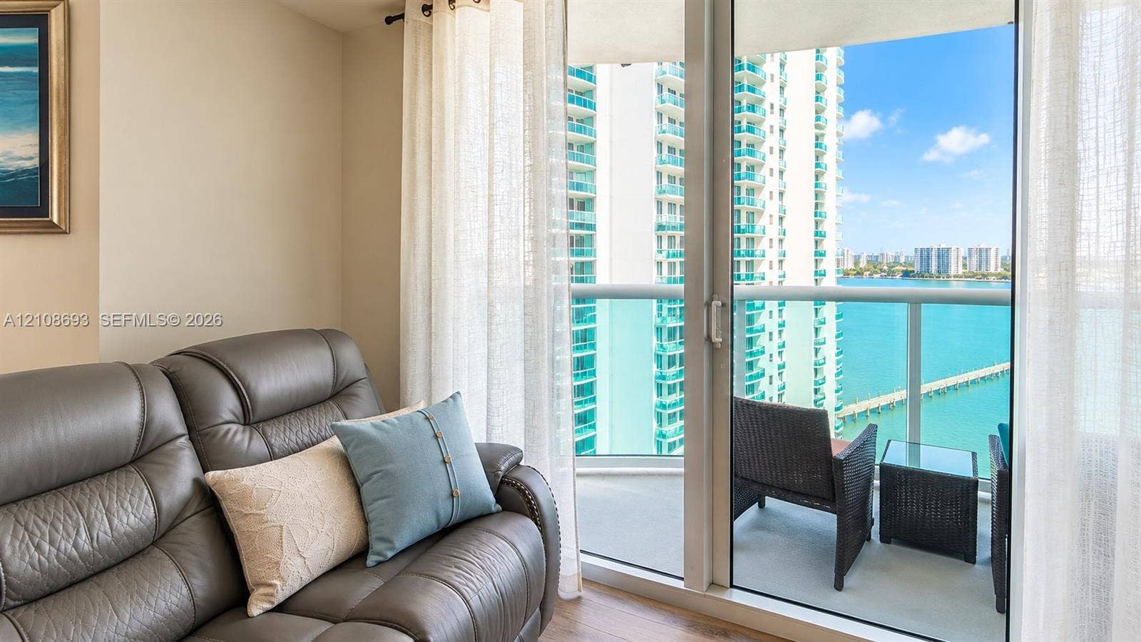 231 Riverside Drive, #1210, Daytona Beach, Daytona Beach, FL 32117 Full-height sliding glass doors with access to a private balcony featuring a glass railing and water backdrop