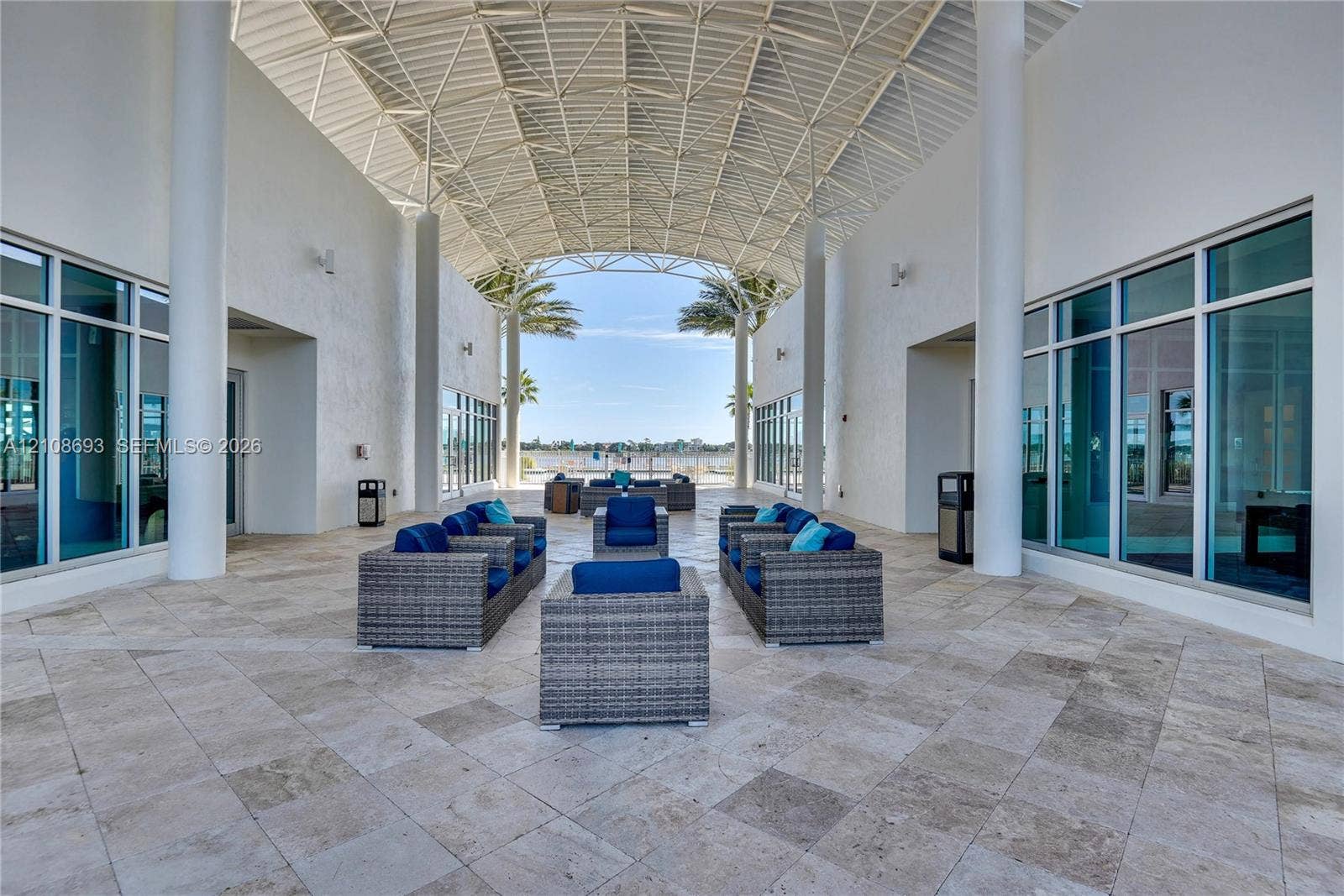231 Riverside Drive, #1210, Daytona Beach, Daytona Beach, FL 32117 Covered open-air pavilion featuring an expansive vaulted lattice ceiling, structural columns, stone tile flooring, and floor-to-ceiling glass windows
