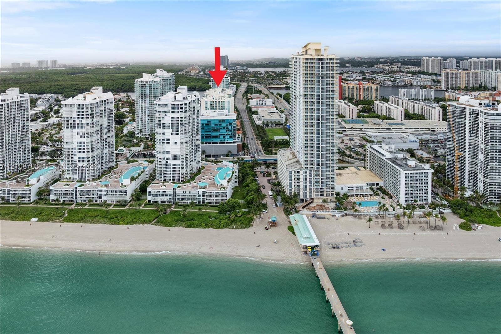 300 Sunny Isles Boulevard, #4-1501, Sunny Isles Beach, Sunny Isles Beach, FL 33160 High-rise condominium building featuring glass exterior cladding, expansive terraces, and immediate proximity to the Atlantic coastline