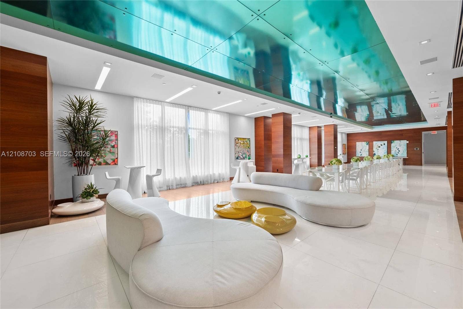 300 Sunny Isles Boulevard, #4-1501, Sunny Isles Beach, Sunny Isles Beach, FL 33160 Expansive interior featuring a high-gloss reflective ceiling, wood-paneled support columns, polished tile flooring, and floor-to-ceiling windows with integrated drapery