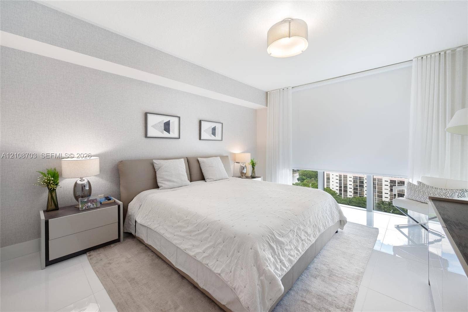 300 Sunny Isles Boulevard, #4-1501, Sunny Isles Beach, Sunny Isles Beach, FL 33160 Floor-to-ceiling windows featuring automated roller shades, gloss-finish tile flooring, neutral wall texturing, and a modern drum-style flush-mount ceiling light fixture