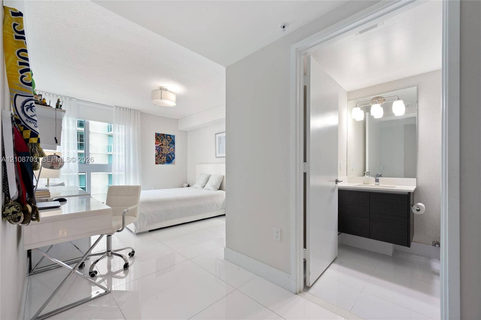 300 Sunny Isles Boulevard, #4-1501, Sunny Isles Beach, Sunny Isles Beach, FL 33160 Large-format tile flooring, modern floating vanity with a single basin, frameless wall mirror, and floor-to-ceiling windows
