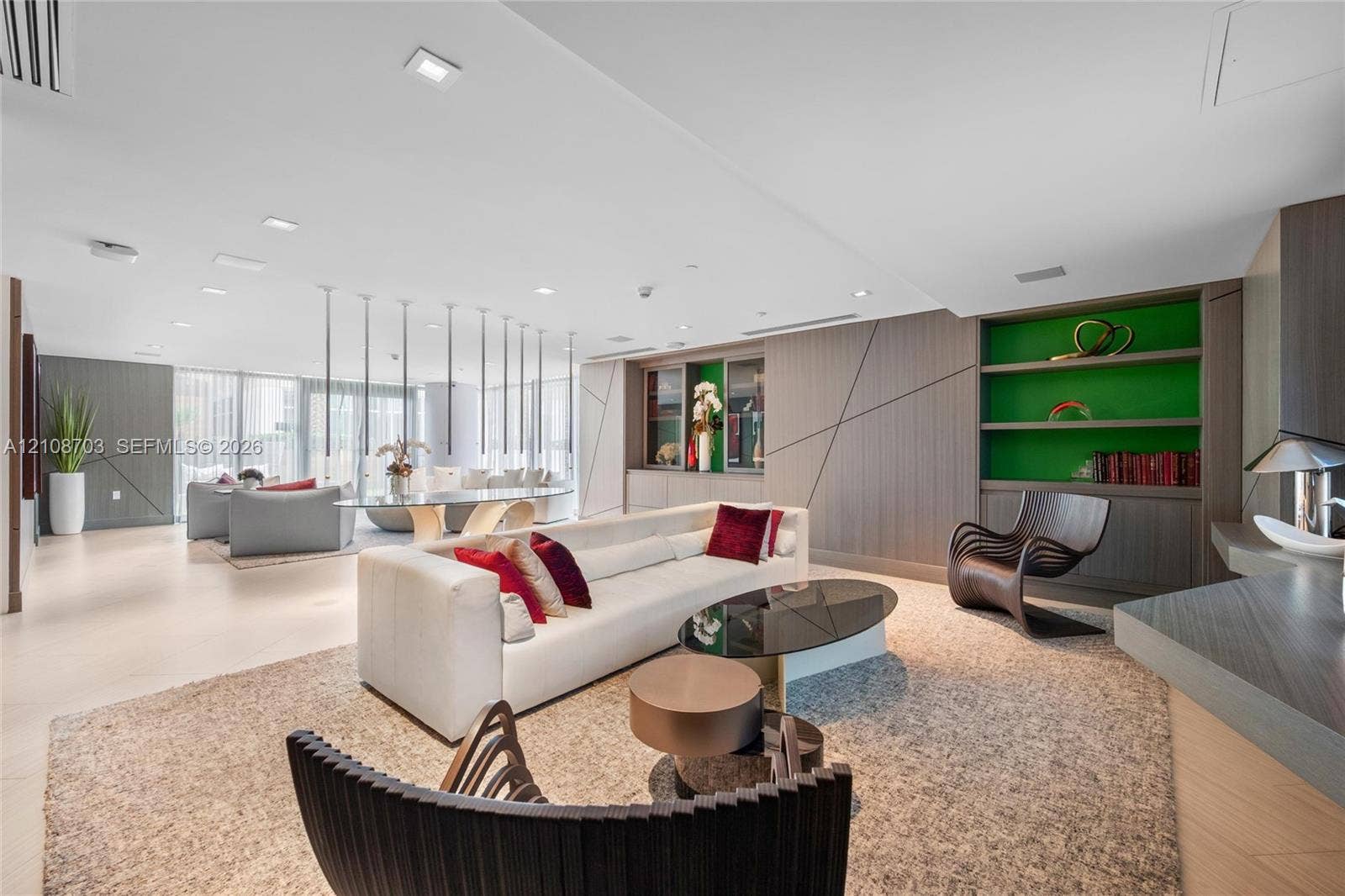 300 Sunny Isles Boulevard, #4-1501, Sunny Isles Beach, Sunny Isles Beach, FL 33160 Open floor plan featuring recessed lighting, floor-to-ceiling windows, integrated wall paneling, and custom built-in shelving with a contrasting accent finish