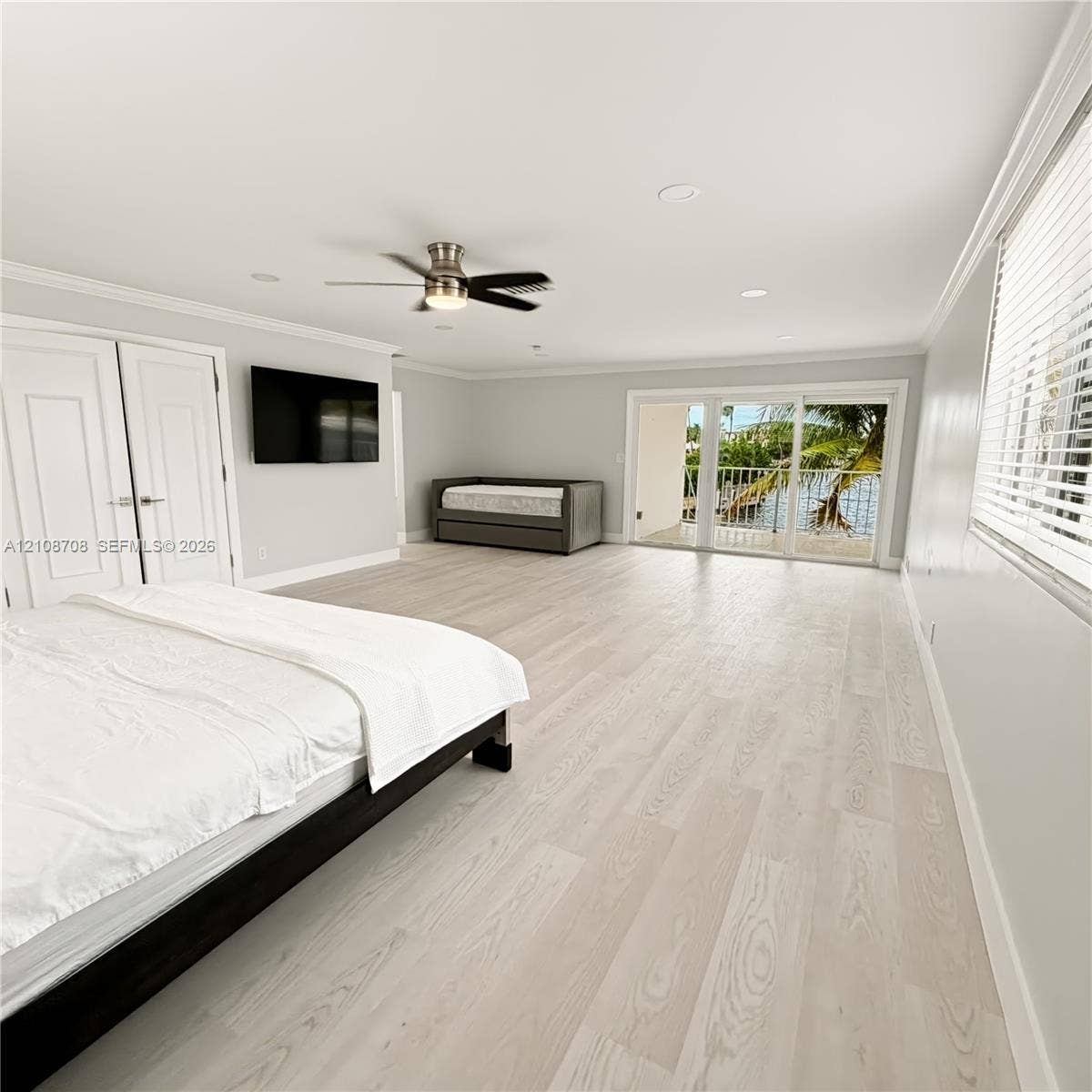 Primary bedroom with glass doors to the balcony