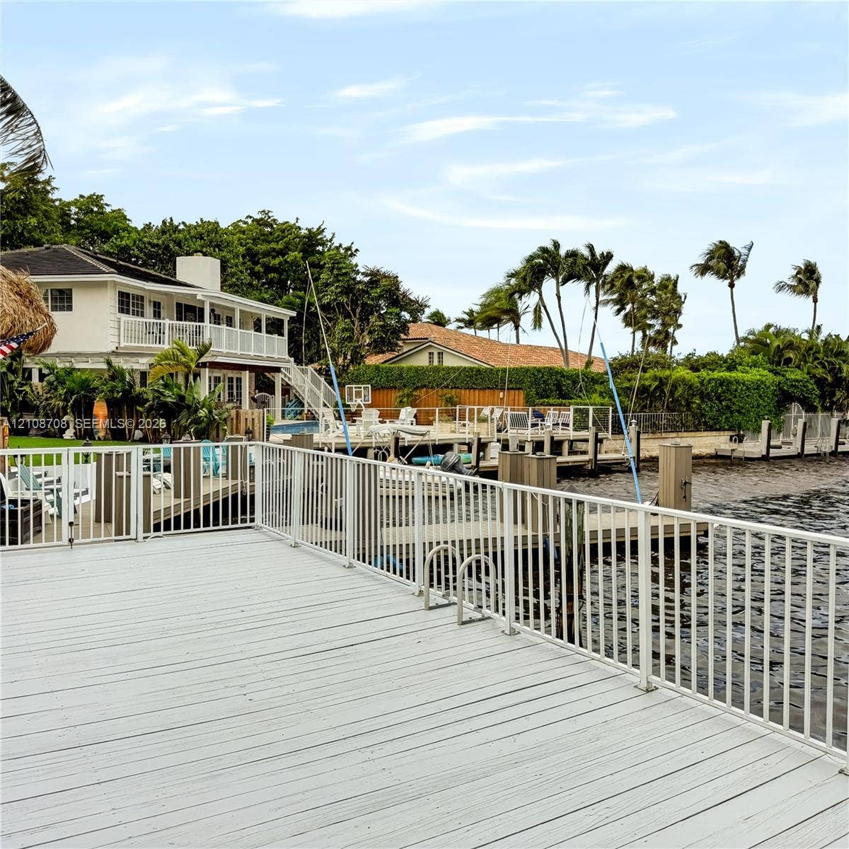 Private waterfront deck with swim ladder and open canal views