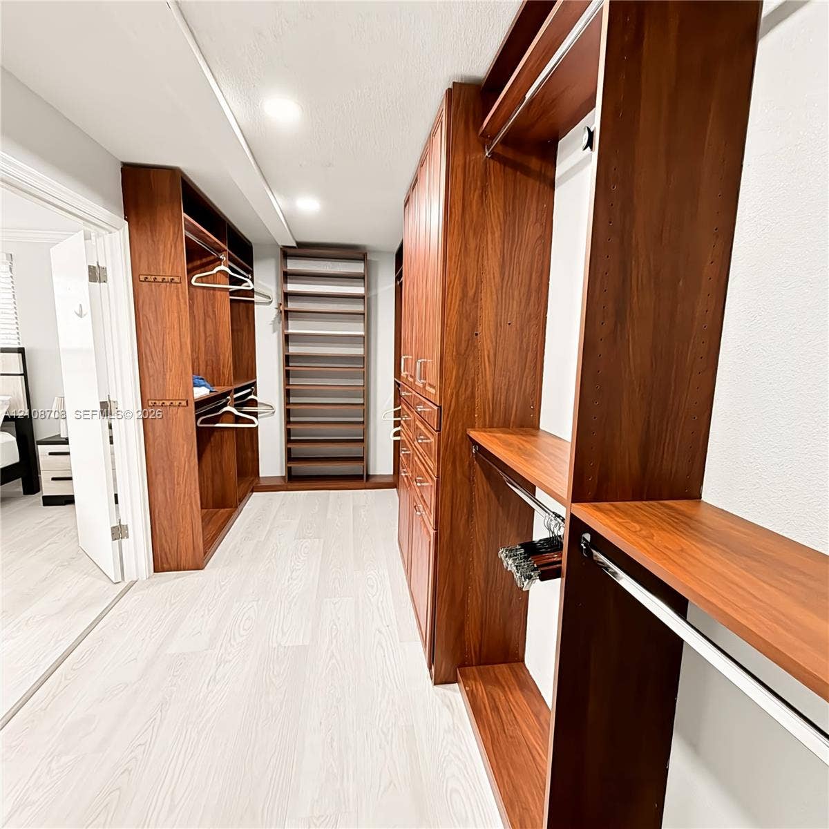 Second walk in closet with custom cabinetry
