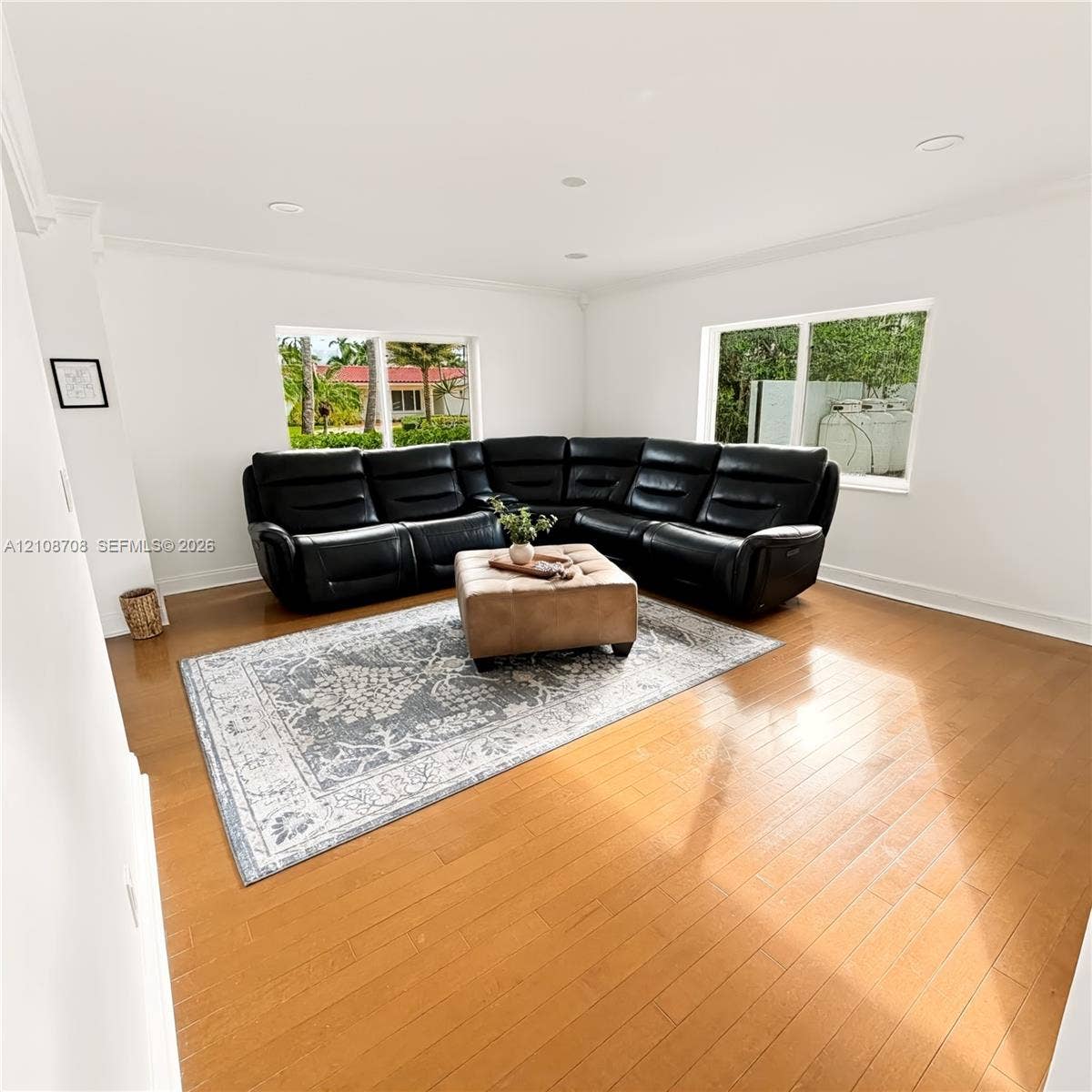 Living room with large windows and crown molding