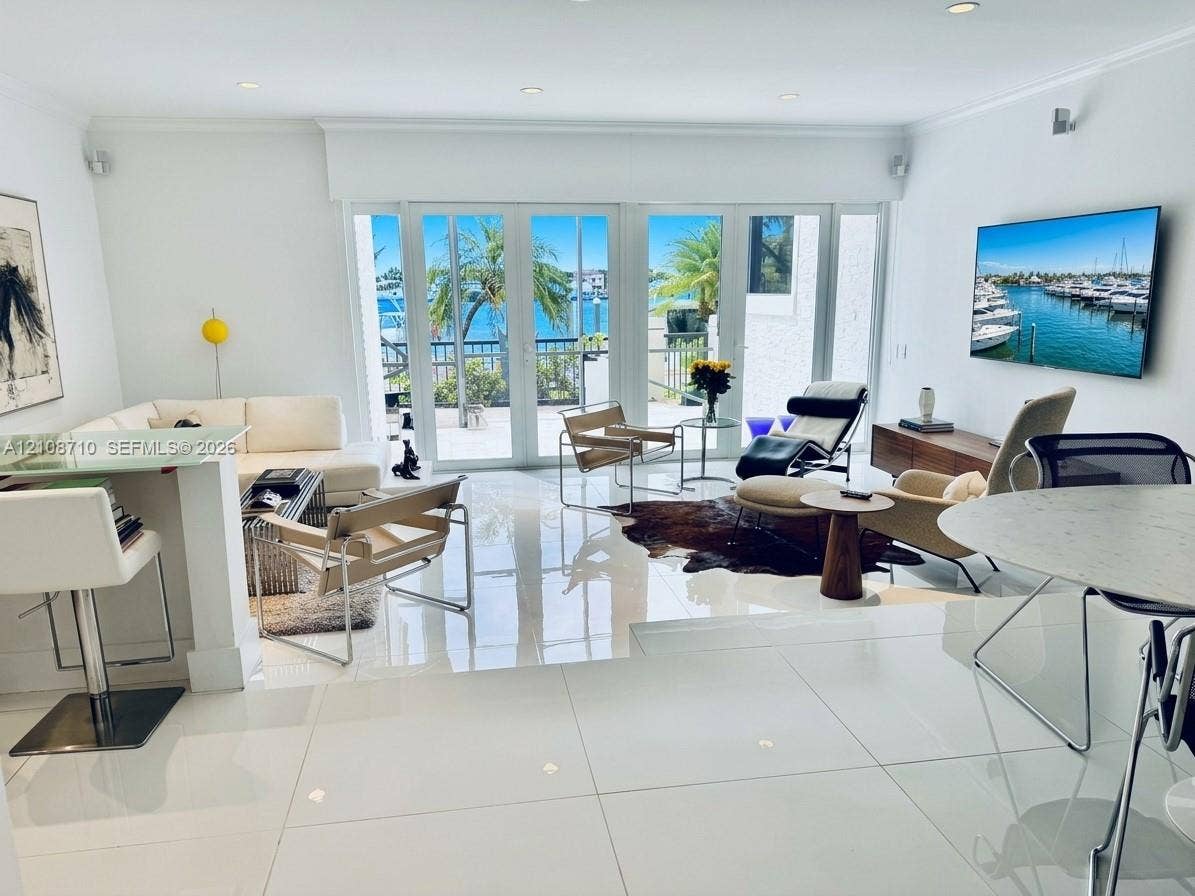 3630 Yacht Club Drive, #605, Aventura, Aventura, FL 33180 Open-concept living space featuring high-gloss tile flooring, recessed lighting, and multi-panel glass doors with a water-facing exterior