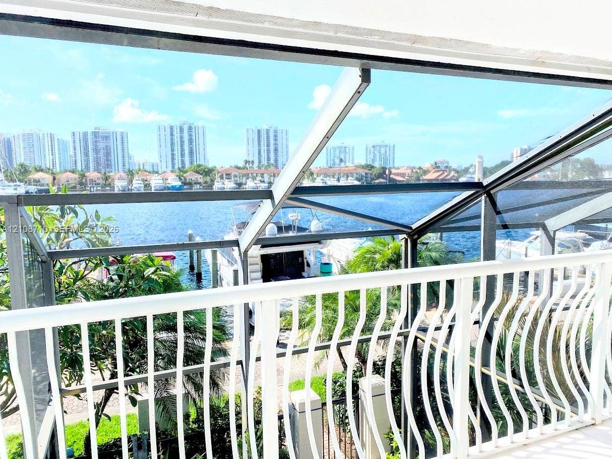 3630 Yacht Club Drive, #605, Aventura, Aventura, FL 33180 Screen-enclosed balcony featuring white metal railings, water frontage, and integrated structural framing