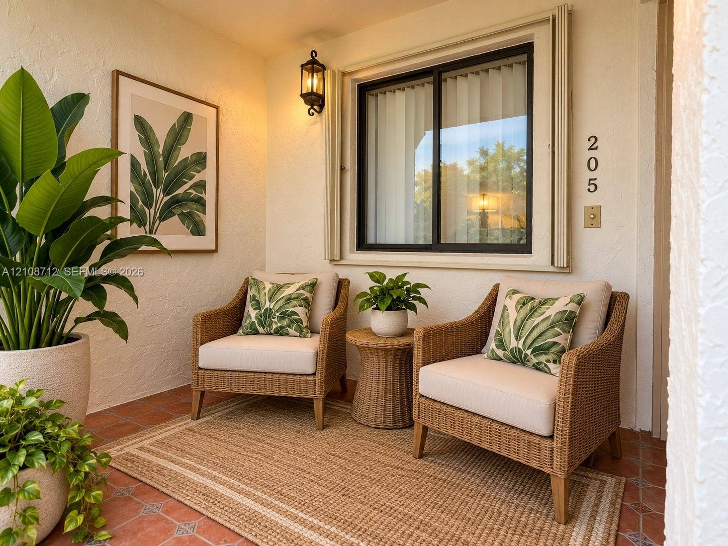 379 Lakeview Drive, #205, Weston, Weston, FL 33326 Stage Covered entryway featuring terracotta tile flooring, exterior wall-mounted lantern-style lighting, and a sliding glass window