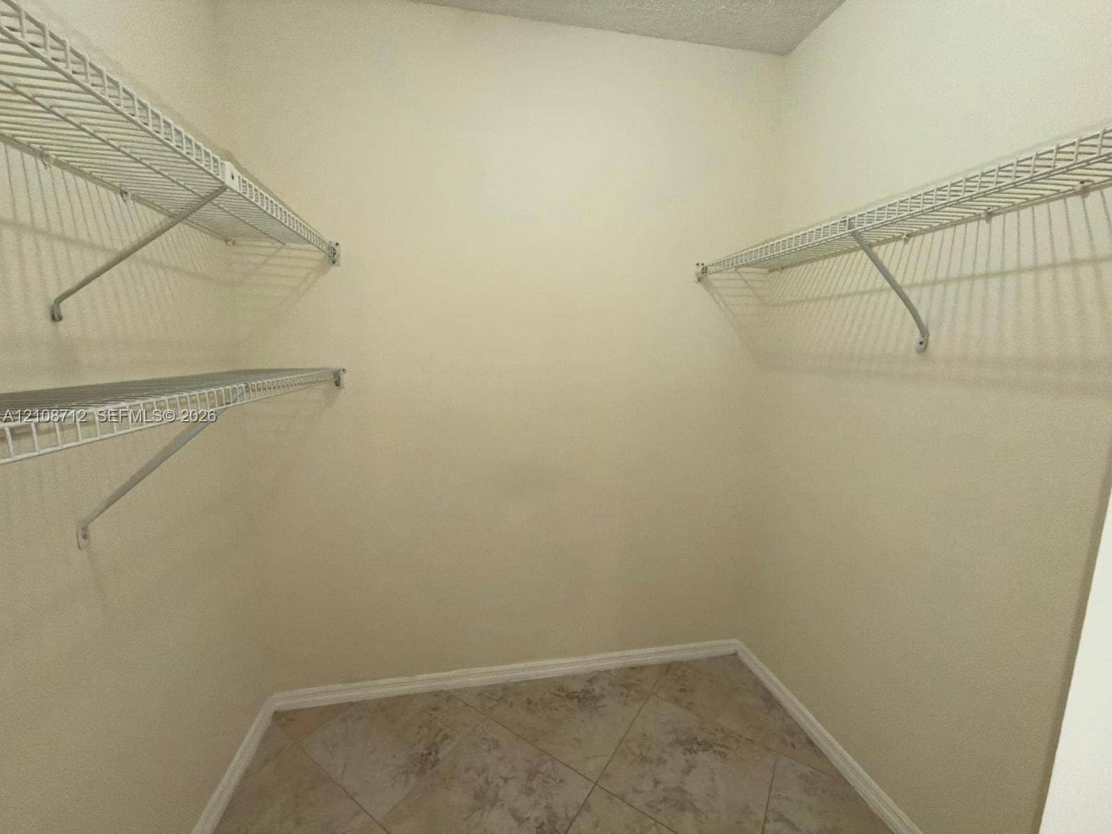 379 Lakeview Drive, #205, Weston, Weston, FL 33326 Storage area featuring neutral-toned tile flooring and wall-mounted wire shelving units