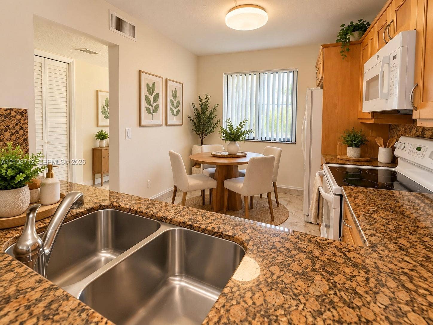 379 Lakeview Drive, #205, Weston, Weston, FL 33326 Stage Kitchen featuring granite countertops, double-basin stainless steel sink with high-arc faucet, natural wood cabinetry, and tile flooring